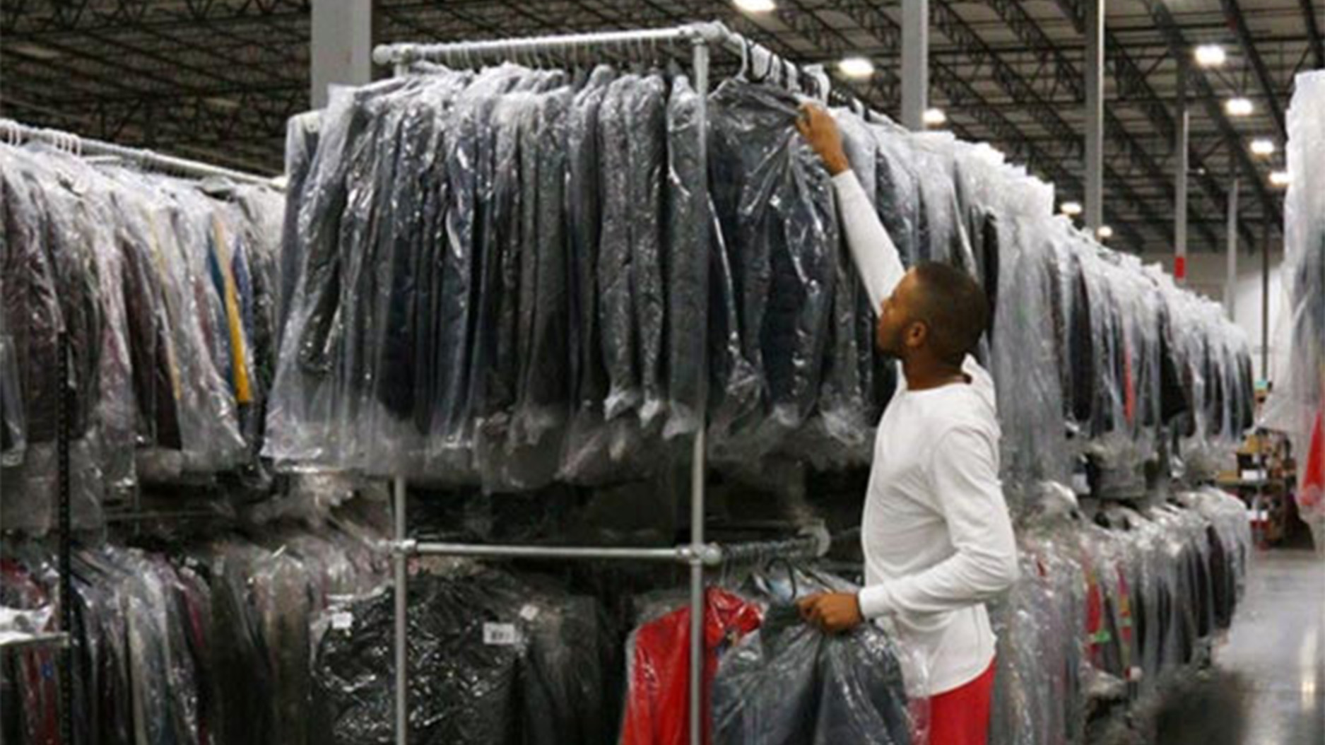 warehouse clothing rack with employee