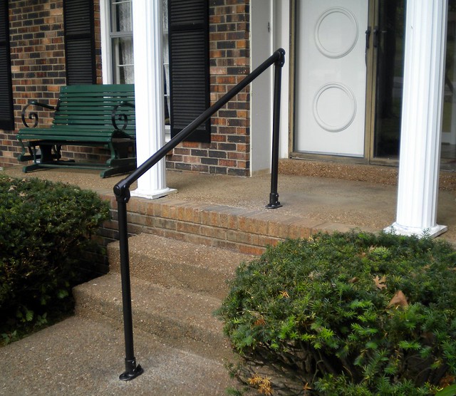 small railing on brick porch front steps