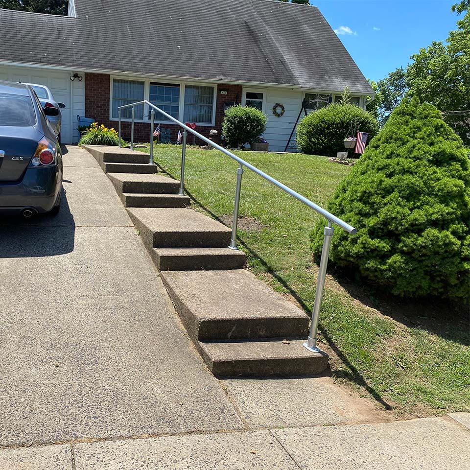 driveway with steps and railing