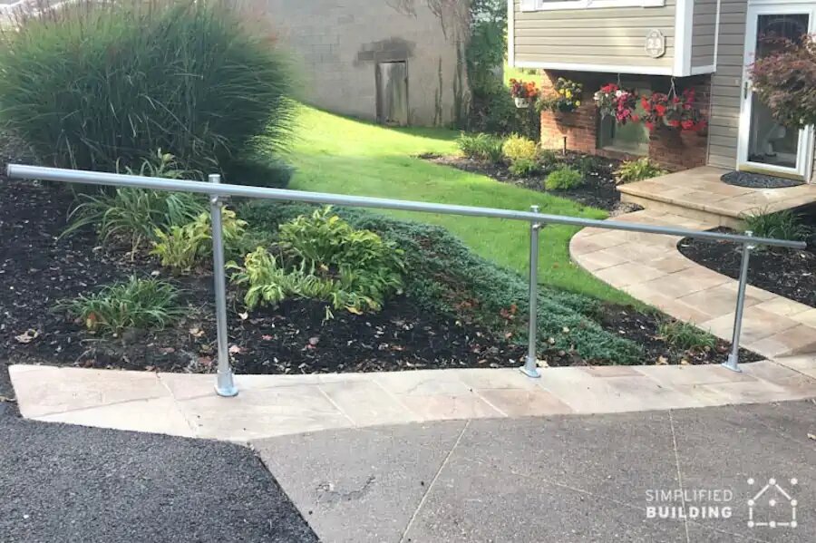 sloped driveway with metal railing