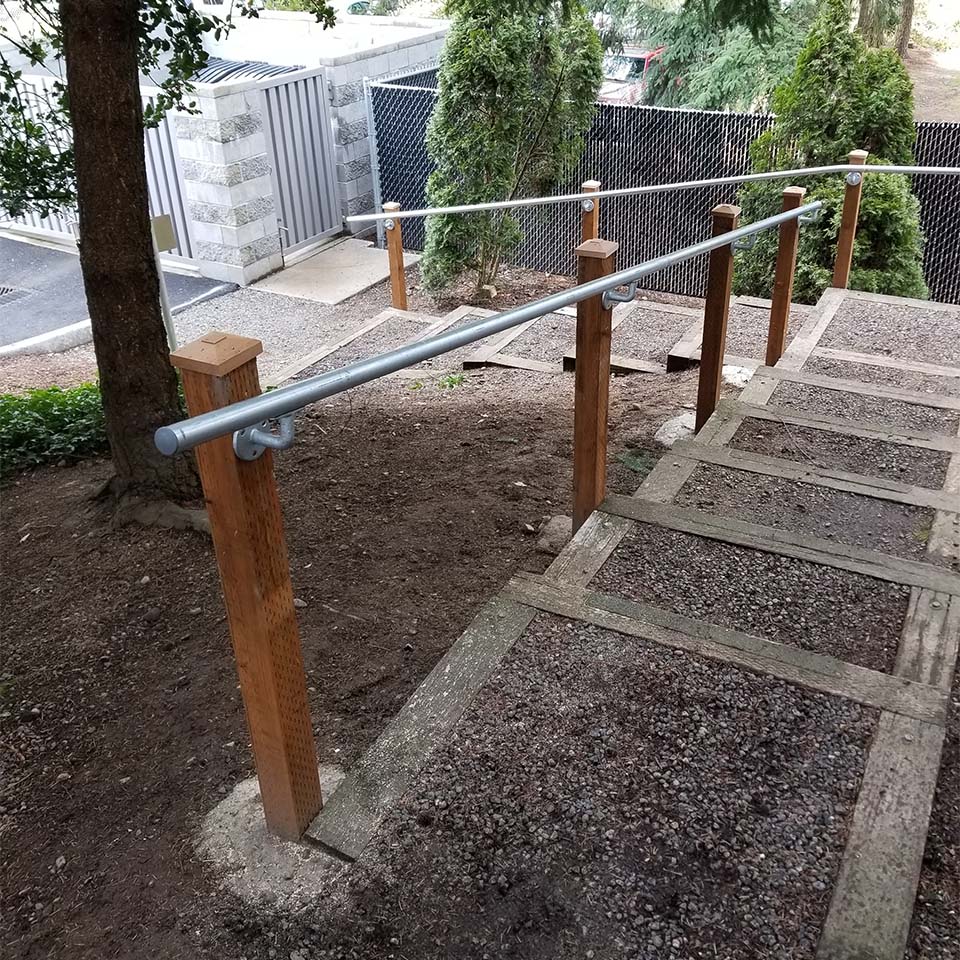 long gravel stairs with wood posts and metal railing