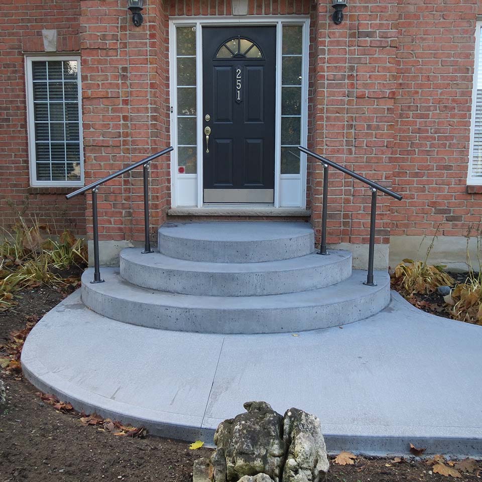 concrete front steps and brick house