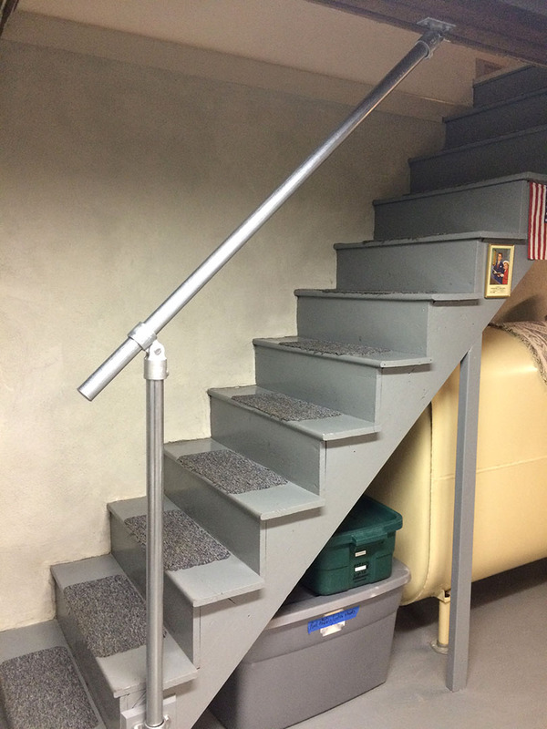wood basement stairs with handrail
