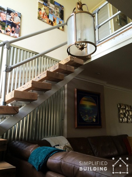rustic wooden stairs with metal handrail