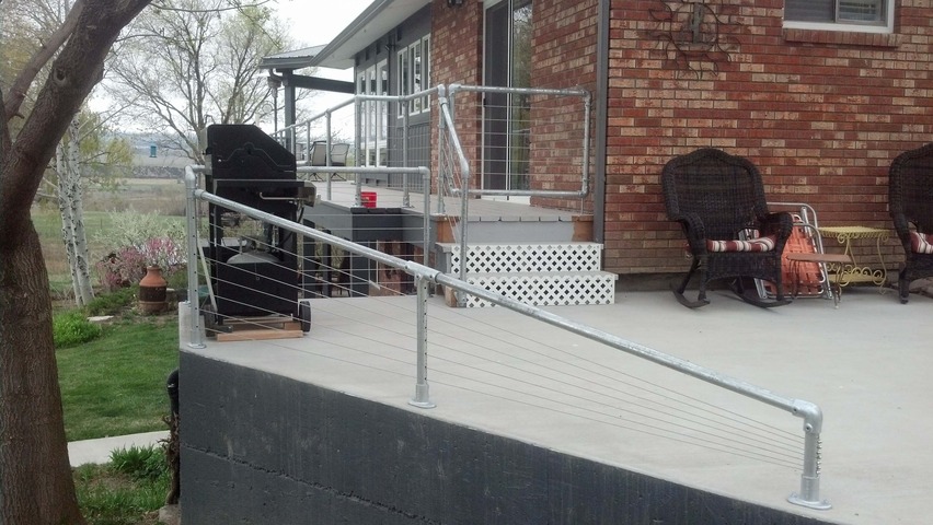 concrete back deck with metal railing