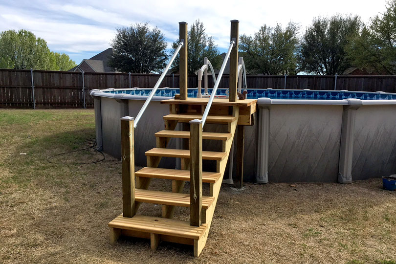 wooden pool stairs with metal railing