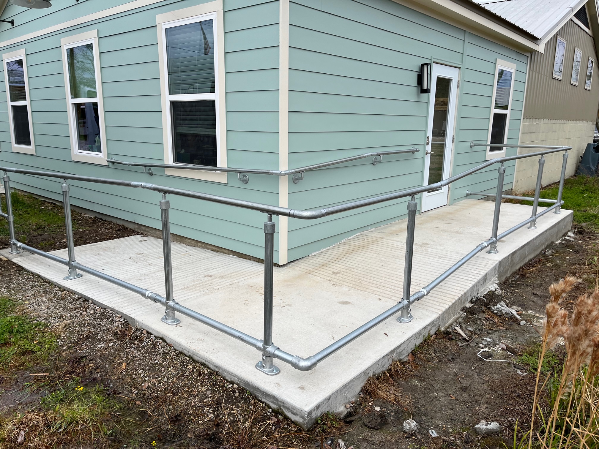 blue house with concrete wheelchair ramp