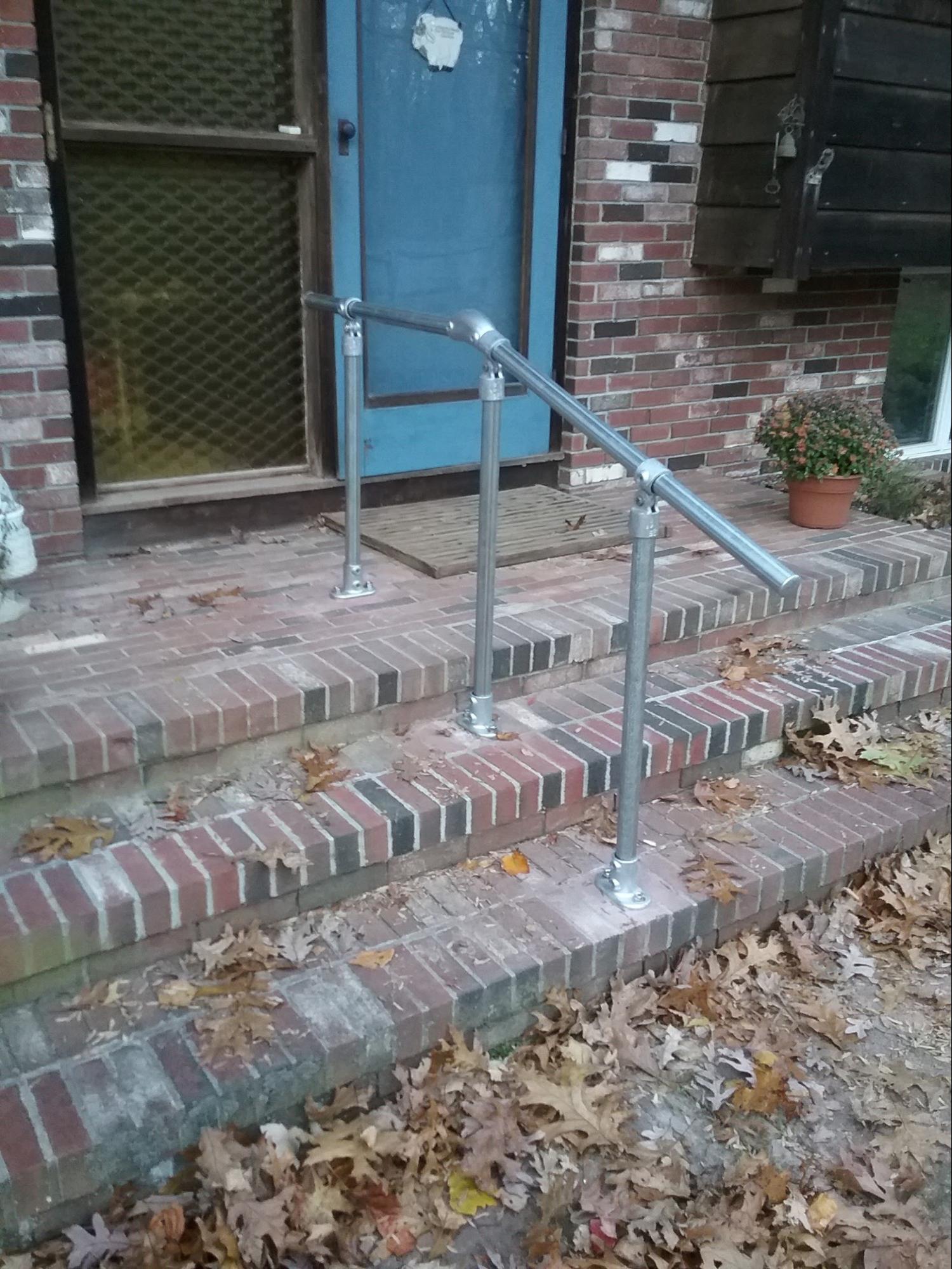 brick porch with metal railing