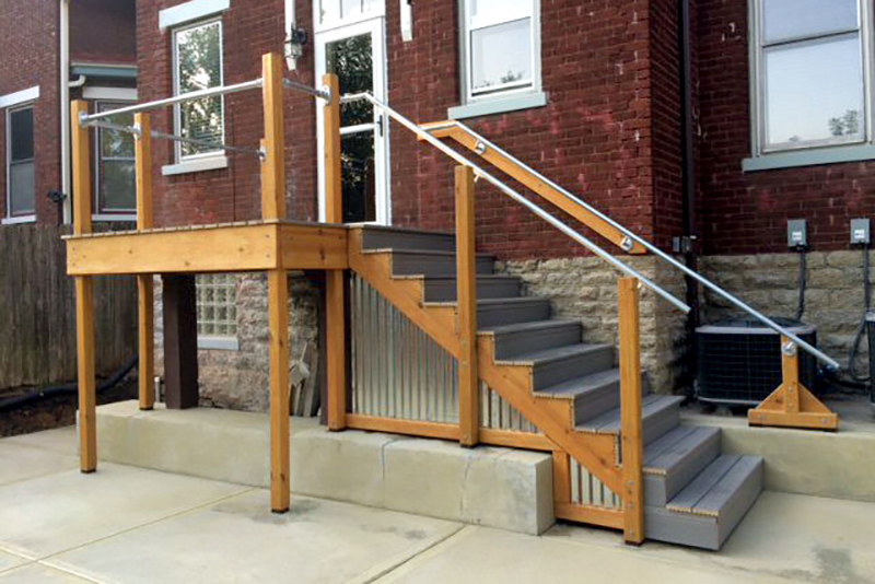elevated front porch and stairs with metal railing
